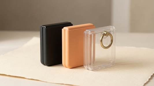 Three Galaxy Z Flip clamshell cases standing in a row on cream paper — the best Z Flip 7 cases for 2026