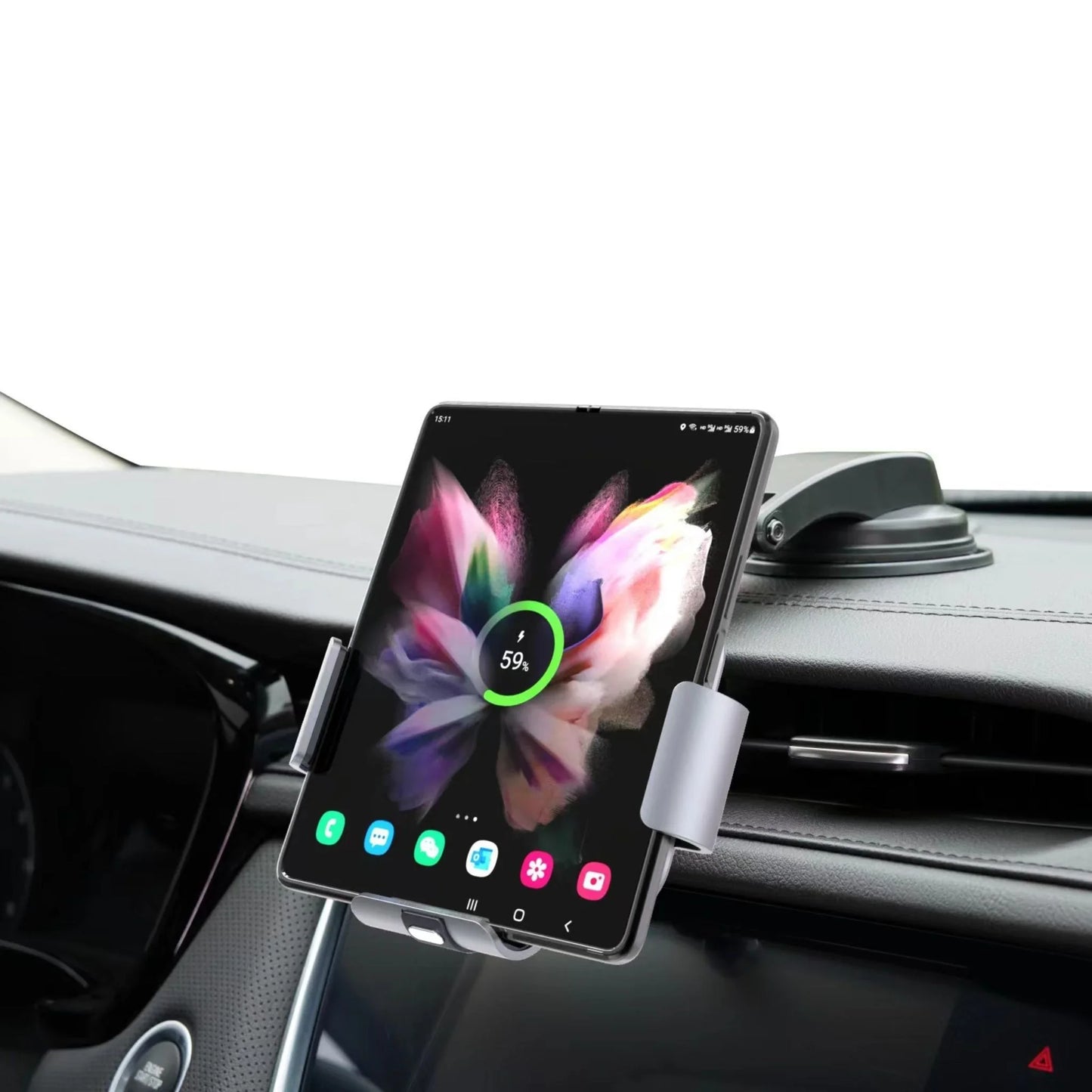 Foldable smartphone charging on car dashboard mount with colorful butterfly screen